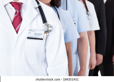 Close-up shot of doctors and business people standing in row - Powered by Shutterstock