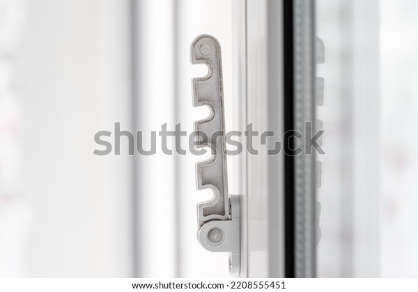 Close-up shot of a\
double-glazed plastic door frame, one-way balcony window handle,PVC\
window latch fixes the sash.House door and window repair concept.\
High quality photo