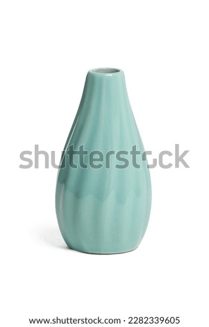 Close-up shot of an empty small ceramic vase covered with glaze. A turquoise glossy vase with a narrow neck is isolated on a white background. Home decor element. Front view.