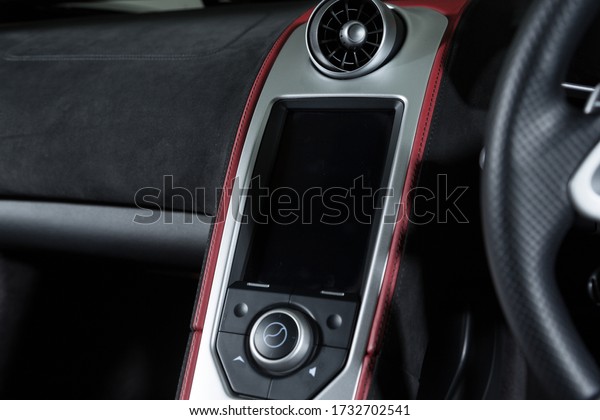 A closeup shot of the engine start buttons inside a\
modern sport car