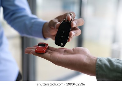 Close-up Shot Of Exchanging Car Keys And Model Cars, Finance Concept, Insurance, Car Seizure.