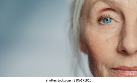 Close-up Shot of an Eyes of Beautiful Senior Woman Looking at Camera and Smiling Wonderfully. Gorgeous Looking Elderly Grandmother with Natural Beauty of Grey Hair, Blue Eyes and Cheerful Worldview