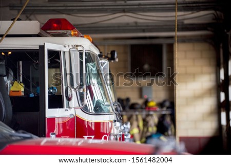 A closeup shot of a firetruck with an open door and a blurred background