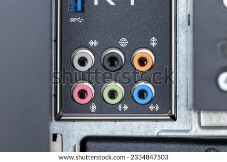 A closeup shot of firewire and small inputs on a digital computer workstation