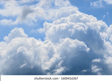 A closeup shot of fluffy white clouds in the beautiful blue sky