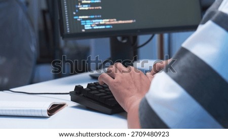 Close-up shot of IT freelancer programmer and tech engineer working with computer keyboard, hand typing software codes for application development and website network system information data in room.