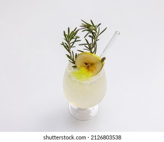 A closeup shot of a fresh pear with rosemary