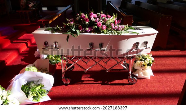closeup shot of a funeral casket or coffin\
in a hearse or chapel or burial at\
cemetery\

