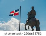 A closeup shot of the General Gregorio Luperon statue and the flag of Dominican Republic