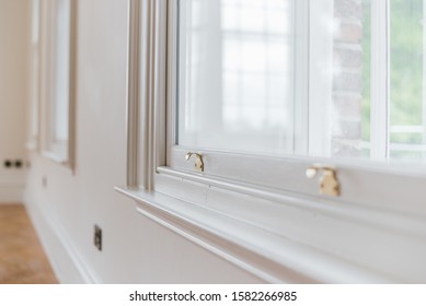 A Closeup Shot Of A Gold Sash Lock On A White Window