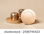 Close-up shot of golden casino dice and poker chips on a beige background. The image is perfect for concepts of gambling, luck, and fortune.