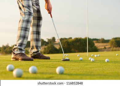 closeup shot of golfer  with golf club during practice - Powered by Shutterstock