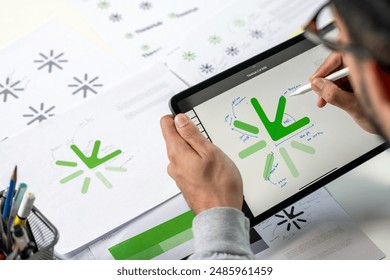 Close-up shot of a graphic designer making notes on logo designs and showcasing the corporate identity and logo design process.	
