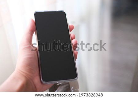 Closeup shot of hand holding handphone