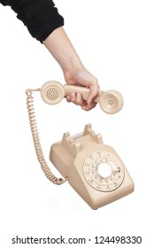 Close-up Shot Of Hand Holding Receiver Of Rotary Dial Phone Over White Background