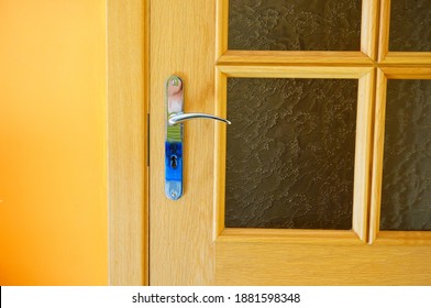 A closeup shot of a handle of wooden door lock - Shutterstock ID 1881598348