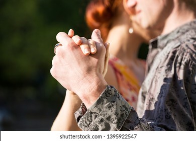 Closeup Shot Of The Hands Of Two Young People Dancing Tango Outside