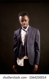 Closeup Shot Of Happy Drunk Afro Businessman With Ragged Clothes After Party Isolated On The Black Background. Sloppy Man