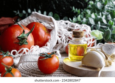 Close-up shot of healthy Mediterranean ingredients: olive oil, garlic and red tomatoes in a sustainable shopping bag. - Powered by Shutterstock