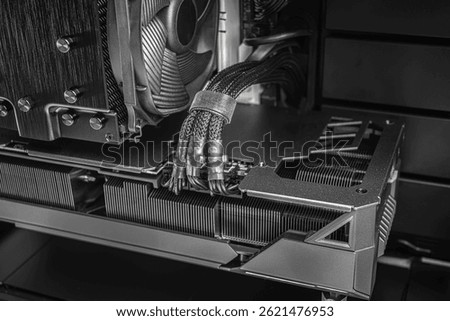 A close-up shot of a high-performance CPU cooler, braided power cables, and cooling fins within a custom-built desktop PC