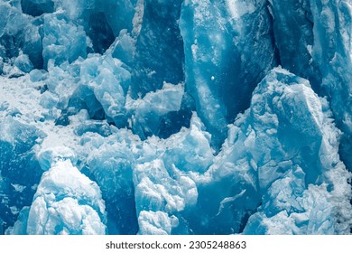 A closeup shot of the ice texture of a blue glacial wall in Inside Passage, Alaska