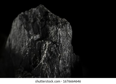 A Closeup Shot Of An Igneous Rock Isolated On A Black Background