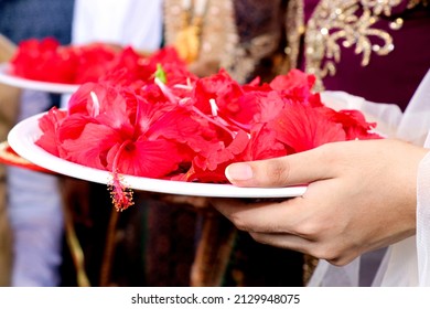 A Closeup Shot Of Indian Woman Holding A Plate With Flower Petals With Henna In Her Hands In Indian Ritual