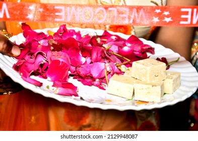 A Closeup Shot Of Indian Woman Holding A Plate With Flower Petals With Henna In Her Hands In Indian Ritual