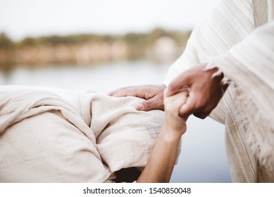 A closeup shot of Jesus Christ healing the female with a blurred background - Shutterstock ID 1540850048