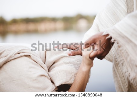 A closeup shot of Jesus Christ healing the female with a blurred background