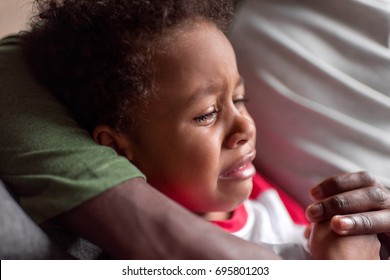 Close-up Shot Little African Boy Crying While Sitting With Father