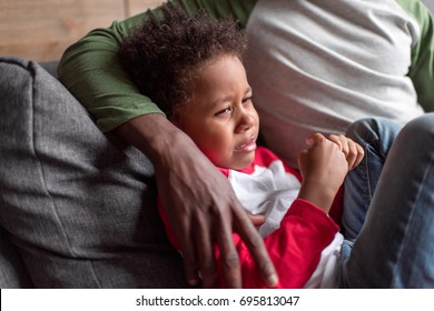 Close-up Shot Little African Boy Crying While Sitting With Father