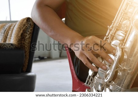 Close-up shot of male musician playing saxophone, selectable focus