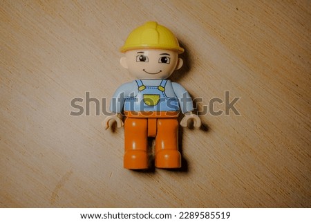 Closeup shot of a male project worker toy on a modern wooden background