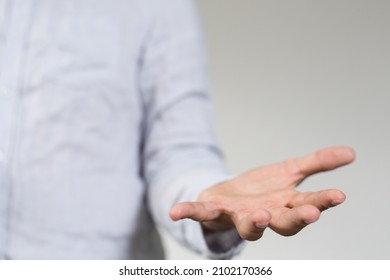 A Closeup Shot Of A Male In A Shirt With An Open Fist