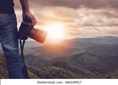 Close-up Shot Of Man  Holding Camera  Standing On The Hill