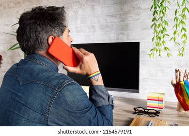 A Close-up Shot Of A Man Working In An Office With LGBT Accessories