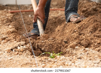 Close-up Shot Of A Man's Hand Digging With A Shovel In The Ground