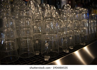 A Closeup Shot Of Many Glasses Stacked At The Bar