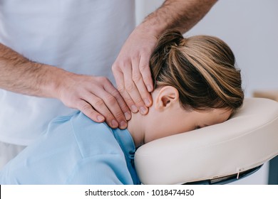 close-up shot of masseur doing neck massage for businesswoman