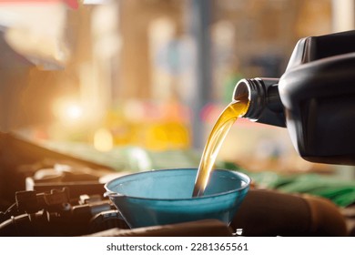 Close-up shot of a mechanic changing new oil to a car At a service center or car oil change shop Car warehouse for the automobile industry - Powered by Shutterstock