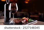 A close-up shot of a medium-rare cooked steak on a wooden cutting board, with a glass of red wine in the foreground. In the background, a wine bottle, with a dark label, is slightly out of focus.