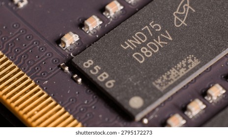 Close-up shot of a memory module showing detailed electronic components and gold connector pins.