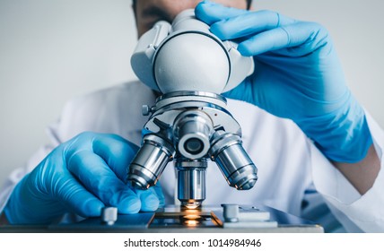 Close-up shot of microscope with metal lens at laboratory.