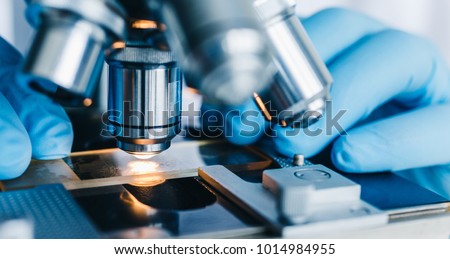 Close-up shot of microscope with metal lens at laboratory.