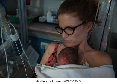 A closeup shot of a mother holds her two days old premature son
