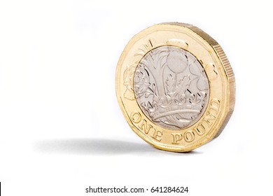 A close-up shot of the new British one pound coin over a white background.