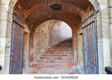 A closeup shot of an old brick arc leading to a staircase - Shutterstock ID 1914198226