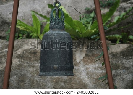 Close-up shot of the old vintage bell with garden background. 