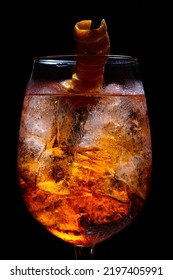 Closeup Shot Of Orange Spritzer Drink, With Bubbles And Ice Cube Details - Vertical Shot